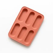 Framsida av form i silikon till grötpinnar för barn i färgen soft terracotta